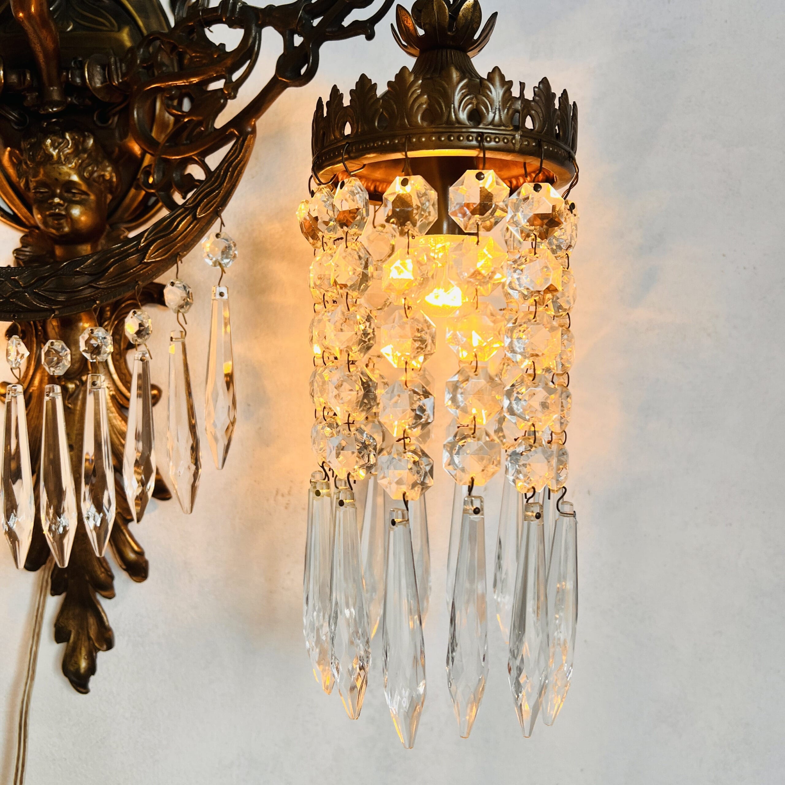 French bronze cherub wall sconce with crystal prisms, 1930s baroque angel lamp, two-arm putti light fixture for home decor