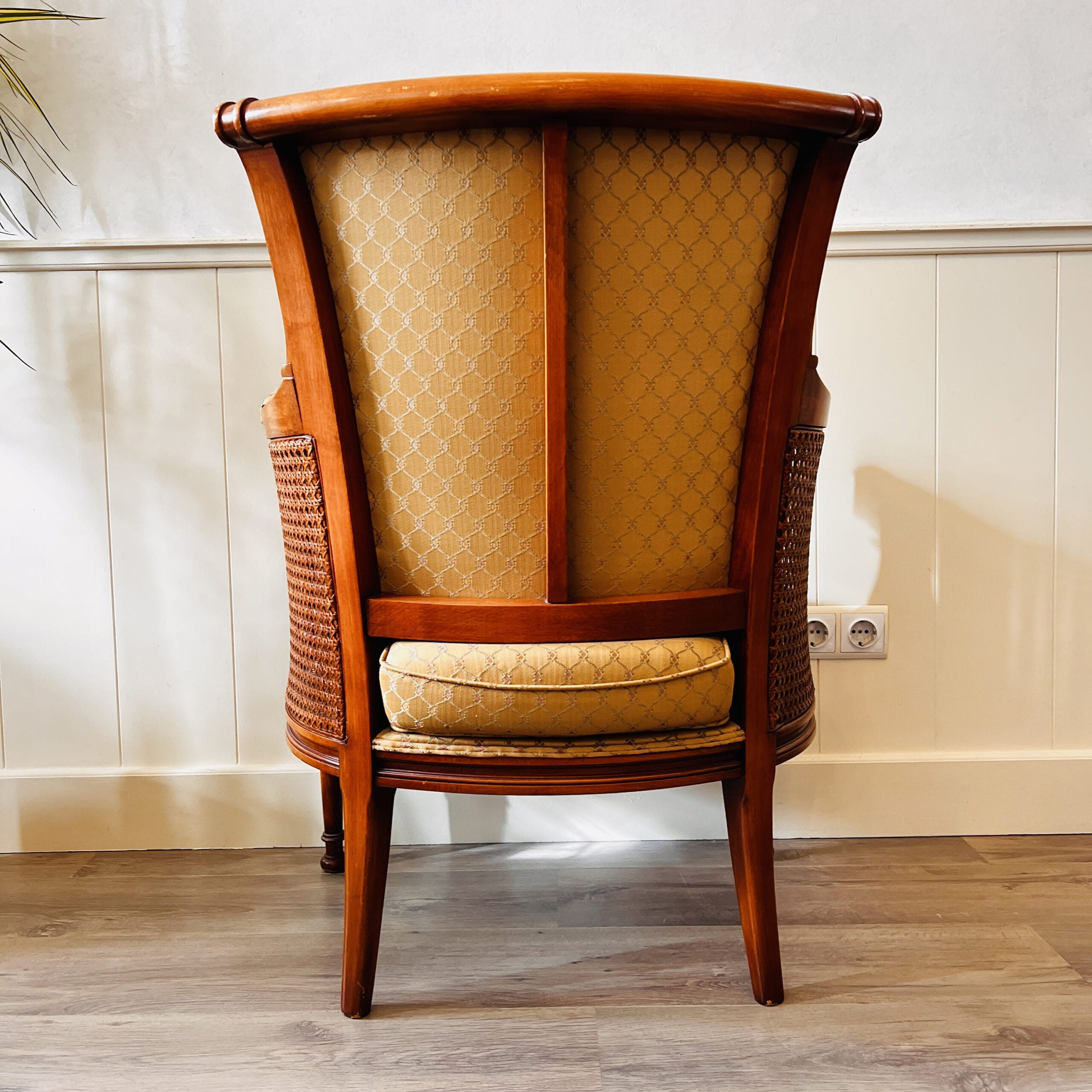 French Louis XVI cane and wood bergère chairs, elegant armchairs with wraparound arms, vintage pair for curated living spaces