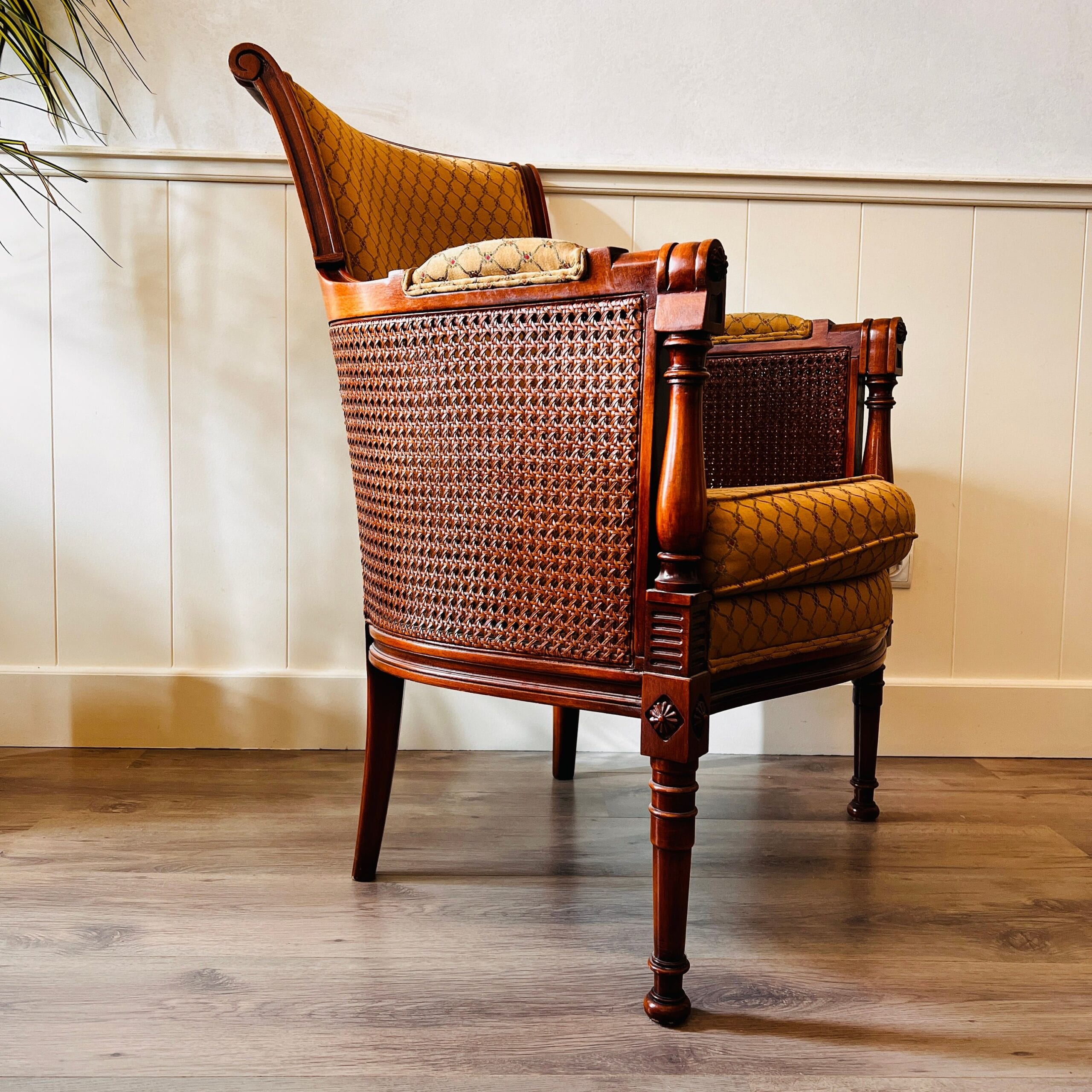 French Louis XVI cane and wood bergère chairs, elegant armchairs with wraparound arms, vintage pair for curated living spaces